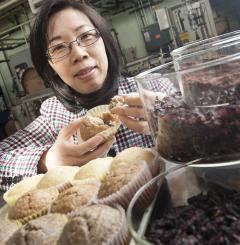 Dr. Yanyun Zhao holds grape pomace muffin