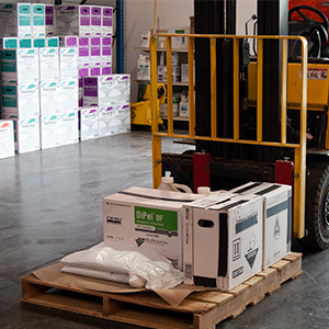 Pesticide storage facility with shelves and a fork lift full of boxes