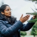 Priya Rajarapu inspecting a Christmas tree in the field